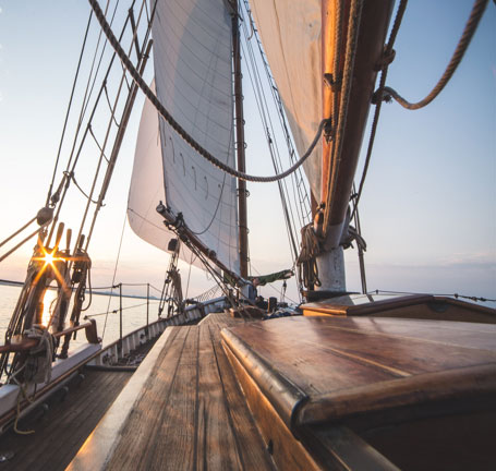 View from inside of a boat with the sunset in the background.